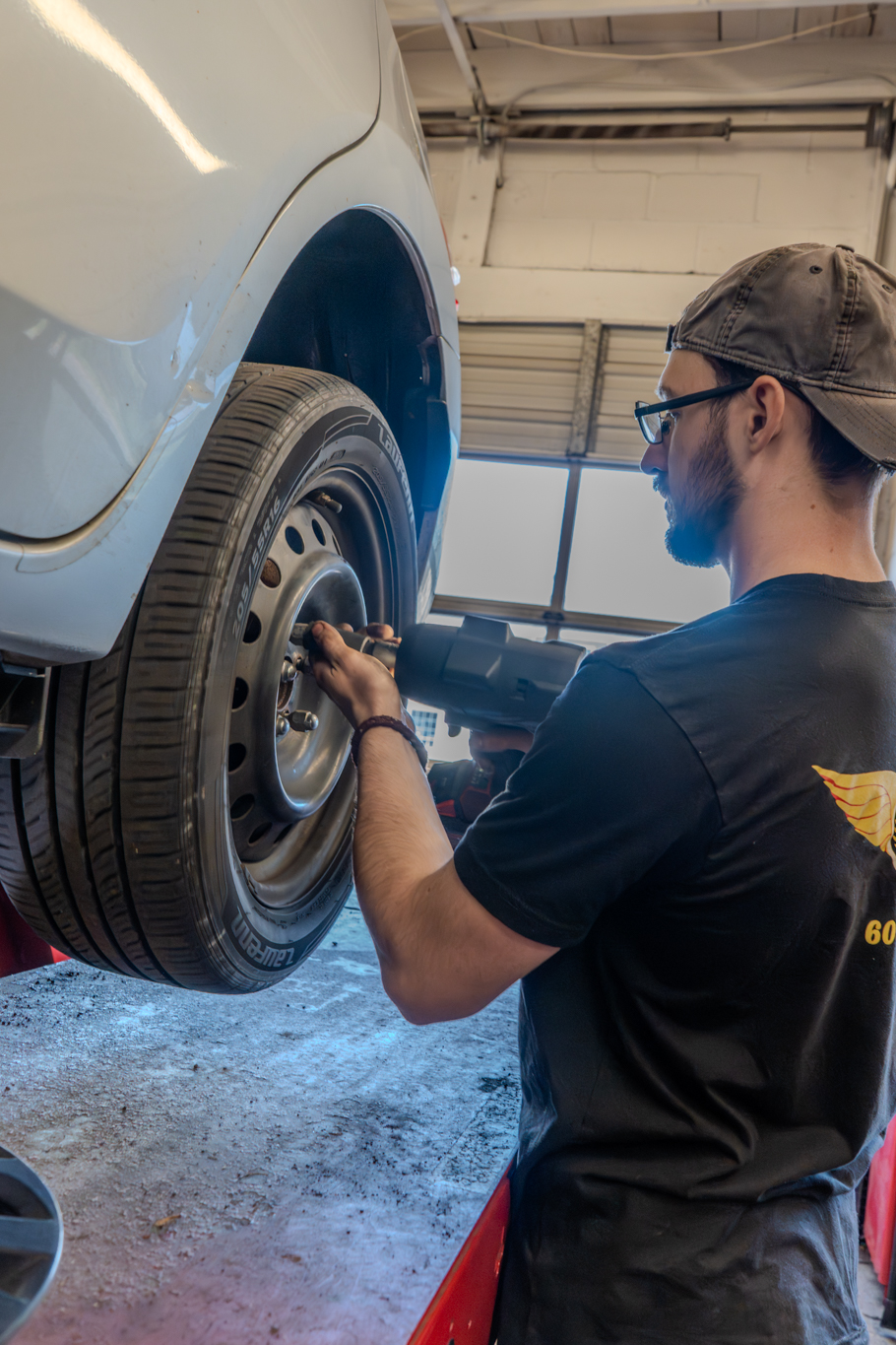 Automotive Technician Working on Tire